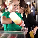 woman bartender pouring a drink