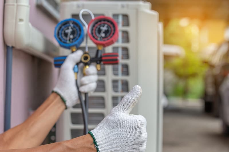 HVAC Technician performing AC maintenance